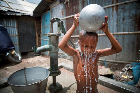 Podle údajů OSN je na světě víc než miliarda lidí, kteří nemají dostatečný přístup k vodě, a přibližně dvě a půl miliardy nemají přístup k základním hygienickým zařízením. Na ilustračním snímku se dítě polévá vodou v Kallyanpuru, jednom ze slumů bangladéšské Dháky